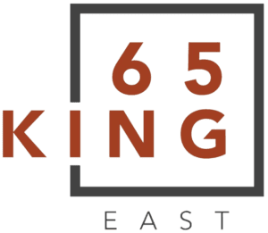 A square housing big bold characters "65" on the top line and "ng" on the bottom line. The letter i lines up with the Box. The character "k" is just outside to the left. At the bottom of the square is the word "East" in small thin letters